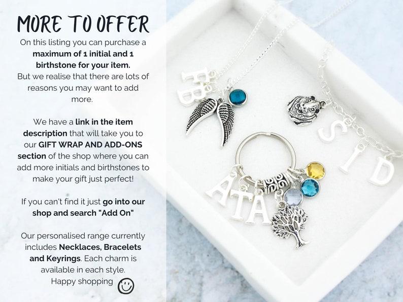May include: A silver necklace with a charm that says "SID" and a charm that says "ATA" with a tree charm and birthstone charms. The necklace is in a white box with the text "MORE TO OFFER" and information about the product.