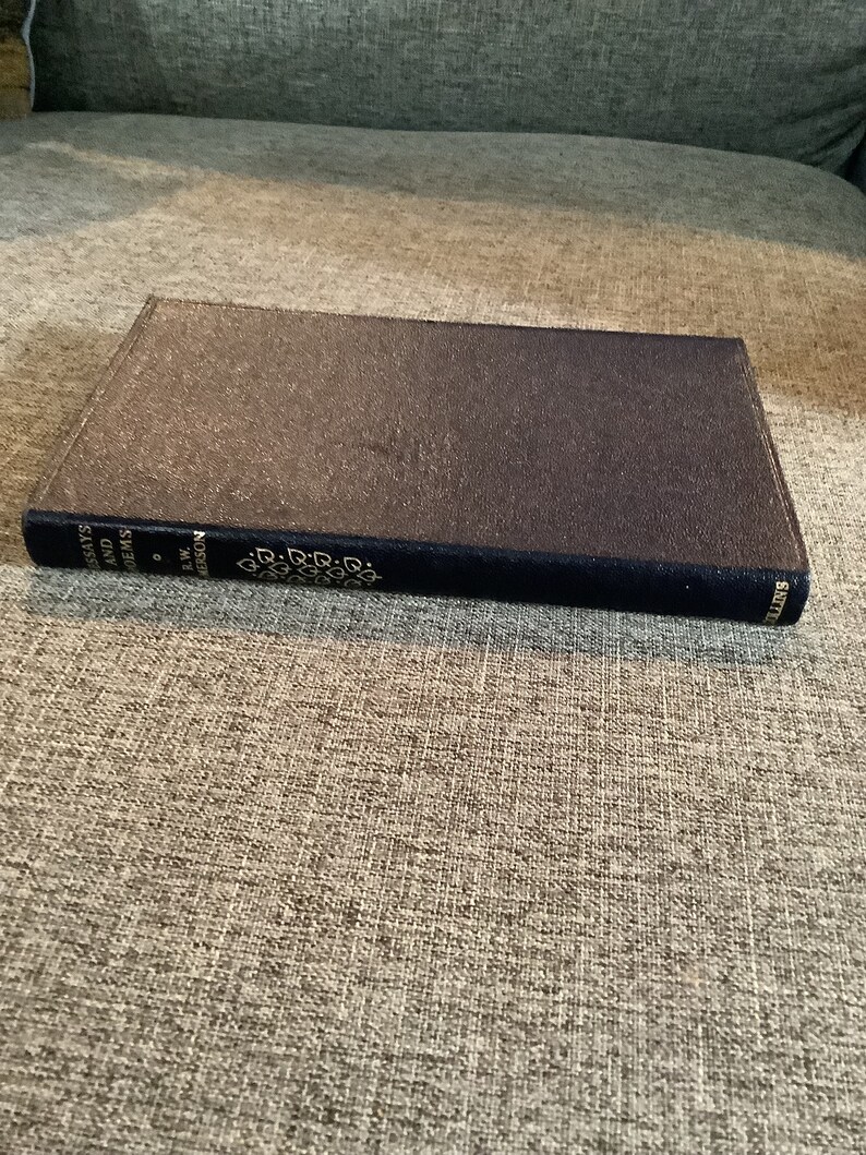 May include: A dark blue hardcover book with gold lettering on the spine. The title is "Essays and Poems" by F.W. Robertson.