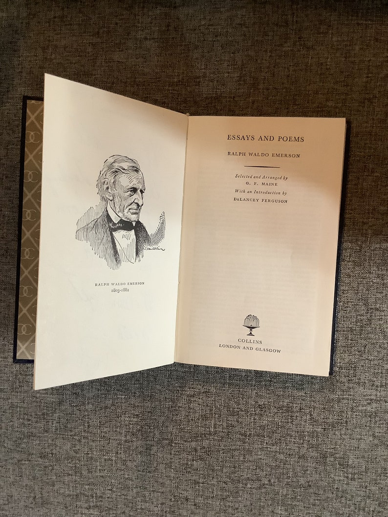 May include: An open book with a black and white illustration of Ralph Waldo Emerson on the left page. The right page has the title "Essays and Poems" by Ralph Waldo Emerson, with the text "Selected and Arranged by G. F. Maine" and "With an Introduction by Delancey Ferguson". The bottom of the right page says "Collins, London and Glasgow".