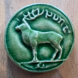 Round ceramic bas-relief  Tile deer inspired by the old Irish coin collection.