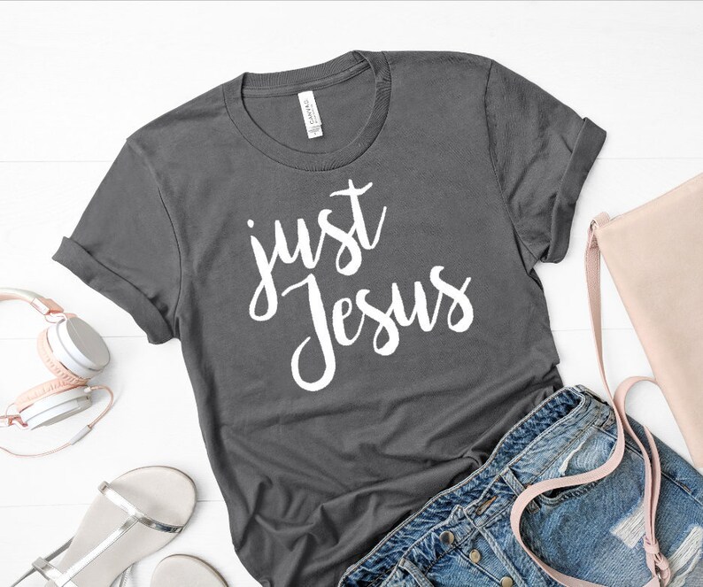 May include: A gray t-shirt with the text "just Jesus" in white lettering.