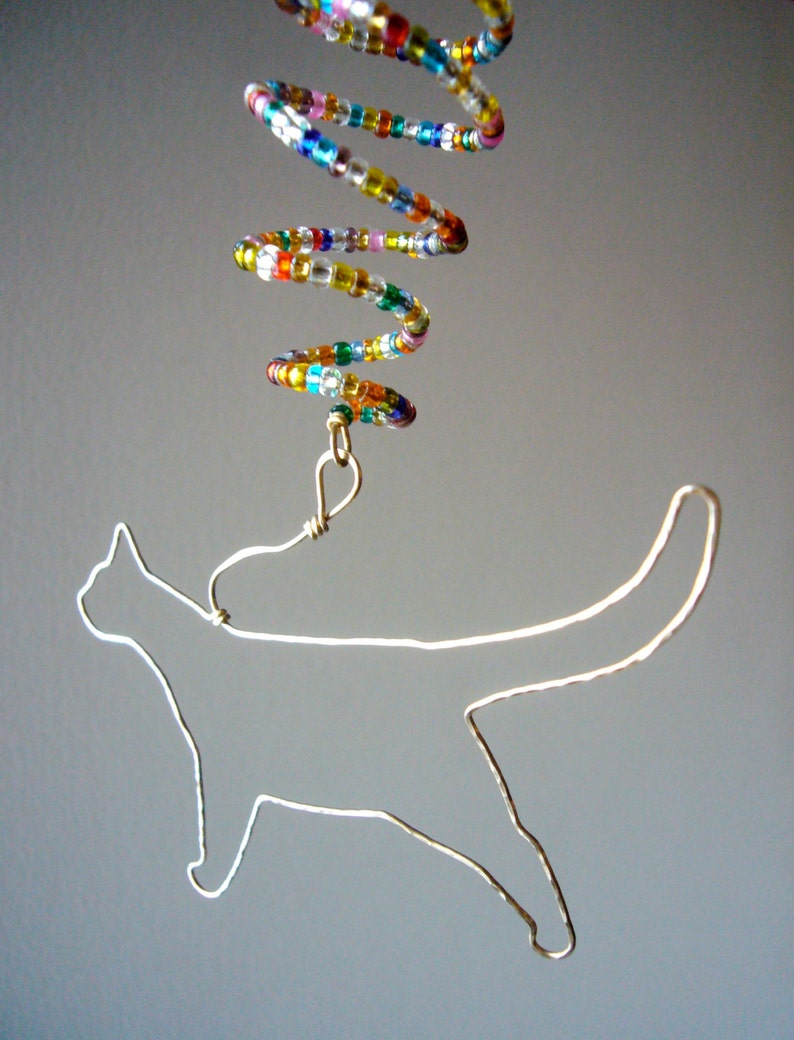 Brass Cat Ornament with Twist.. Hammered brass wire cat ornament with a multi-color seed bead twist