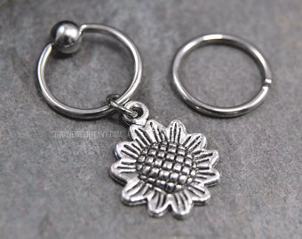 Anillo de cartílago con bola cautiva y diseño de girasol. Aro flexible CBR de acero inoxidable quirúrgico 316L (20 g/18 g/16 g/14 g). Incluye dije de flor plateado de 6 mm a 19 mm.
