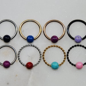 10 COLORES ~ Anillo de cuentas cautivas RIVERSTONE, acero quirúrgico/titanio. Tamaño: 16 g/14 g. Color: plata/oro/oro rosa/negro. Estilo: liso/trenzado. CBR.