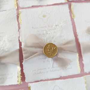 Birth or baptism announcement in handmade cotton paper with a golden cross