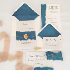 Wedding invitation in handmade craft paper with blue torn edges and wax seal