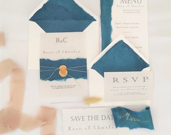 Wedding invitation in handmade craft paper with blue torn edges and wax seal