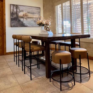 Counter height reclaimed wood table with upholstered stools for dining area, espresso finish.