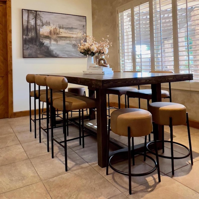 Counter height reclaimed wood table with upholstered stools for dining area, espresso finish.