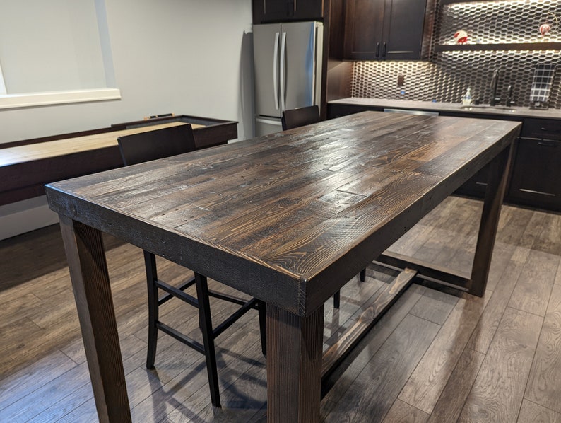 Counter height kitchen island table in reclaimed wood with U-shaped legs, espresso finish.