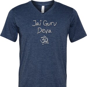May include: A navy blue v-neck t-shirt with the text "Jai Guru Deva" and an Om symbol in silver.