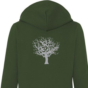 May include: A dark green zip-up hoodie with a white zipper and a front pocket. The back of the hoodie features a silver tree design with an Om symbol. The hoodie has a hood and long sleeves.