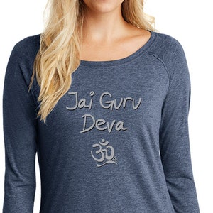 May include: A long-sleeved, blue, heather-grey t-shirt with a white graphic that says "Jai Guru Deva" and a stylized Om symbol.