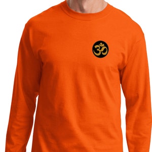 May include: Orange long-sleeve t-shirt with a black circle on the left chest featuring a gold Om symbol.