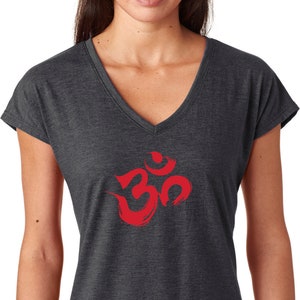 May include: A dark gray V-neck t-shirt with a red Om symbol printed on the front.