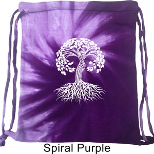 May include: A purple tie-dye drawstring backpack with a white tree of life design. The bag features a spiral pattern and the text "Spiral Purple" at the bottom. The drawstring cords are purple.