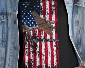 May include: A black t-shirt with a distressed American flag design featuring a B-17 Flying Fortress airplane. The text "B-17 Flying Fortress" is printed below the airplane.