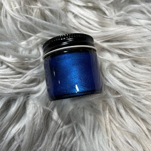 May include: A small jar of blue glitter with a black lid.