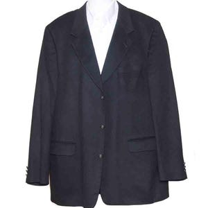 May include: A black blazer with a notched lapel, three-button fastening, and two front pockets. The blazer is worn over a white collared shirt. The sleeves have buttoned cuffs. The garment is displayed on a white mannequin.