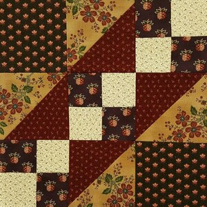 May include: A quilt block with a patchwork design featuring a variety of floral and geometric patterns in shades of brown, cream, and green.