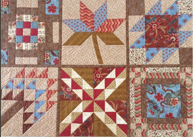 May include: A quilt block with a variety of patterns and colors, including red, blue, brown, and white. The quilt block is made up of smaller squares and triangles, and the patterns are arranged in a geometric design.