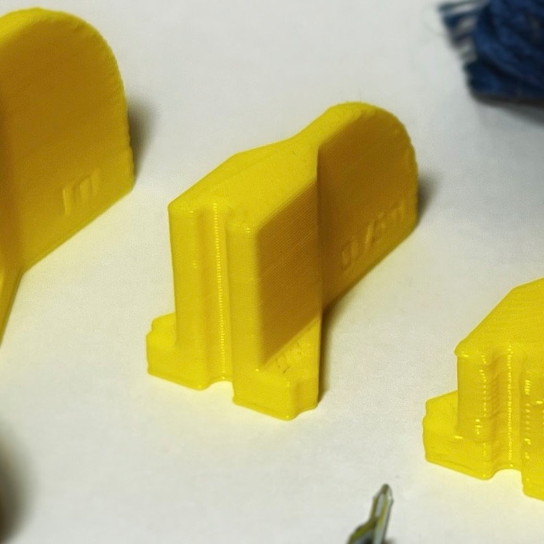 May include: Three yellow plastic pieces with a textured surface. The pieces are shaped like a half-circle, a rectangle, and a square.