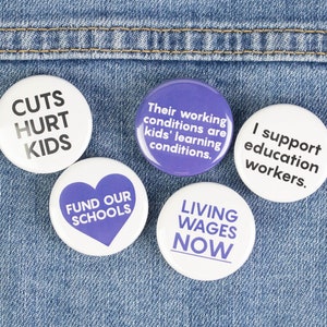 May include: Five round buttons with white backgrounds and purple text. The buttons read "Cuts Hurt Kids", "Fund Our Schools", "Their working conditions are kids' learning conditions.", "I support education workers.", and "Living Wages Now".