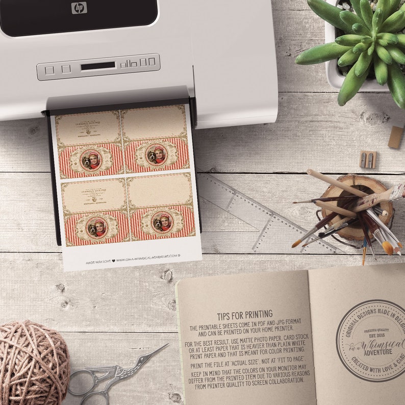 May include: Printable sheets of vintage-style gift tags featuring a red and white striped design with a whimsical illustration of a girl and a dog. The text "Happy Holidays" is printed on the tags. The sheets are printed on a home printer.