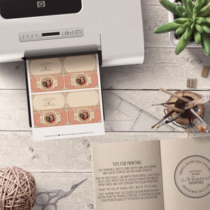 May include: Printable sheets of vintage-style gift tags featuring a red and white striped design with a whimsical illustration of a girl and a dog. The text "Happy Holidays" is printed on the tags. The sheets are printed on a home printer.