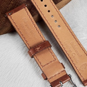 May include: Two brown leather watch straps with stitching. The strap on the left has the text "Full-grain leather Handmade" and the strap on the right has the text "Boldanoﬀ Leather Goods".