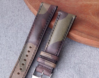 May include: Two brown leather watch straps with a camouflage pattern. The straps have white stitching and a silver buckle.