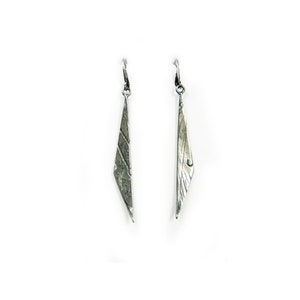 May include: A pair of silver earrings with a geometric, triangular design. The earrings have a textured, hammered finish.