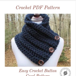 May include: A navy blue crochet cowl with three wooden buttons. The cowl is folded over and draped around a white mannequin. The text "Easy Crochet Button Cowl Pattern" is at the bottom of the image.