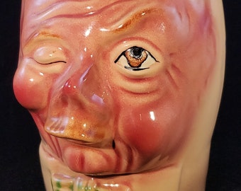 Vintage Unsigned Pink Ugly Face with Bow Tie Decorative Ceramic Toby Jug Musical Box Painted Clouds Branch Shaped Handle Made in Switzerland