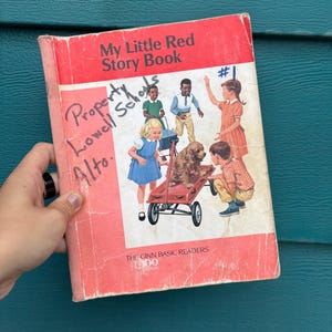 May include: A vintage copy of "My Little Red Story Book" with a red cover and illustrations of children and a dog. The book has handwritten text that reads "Property Lowell Schools Alto."
