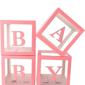May include: Four pink, clear plastic boxes with the letters "BABY" spelled out. Each box has a white background and the letters are cut out of the plastic.