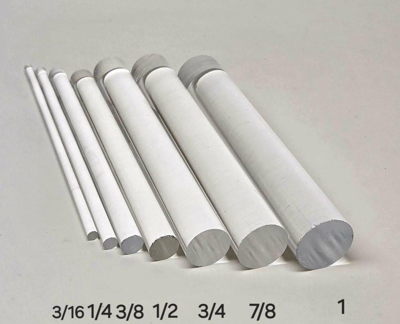 May include: A set of eight clear acrylic rods of varying diameters, labeled with their respective sizes in inches: 3/16, 1/4, 3/8, 1/2, 3/4, 7/8, and 1.