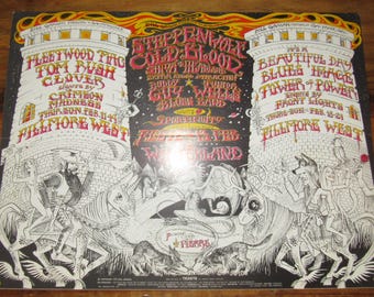 Peut inclure: Affiche de concert vintage pour Fillmore West avec Fleetwood Mac, Steppenwolf et d'autres groupes. L'affiche a un fond noir avec du texte blanc et rouge, et des illustrations de personnages et de tours.