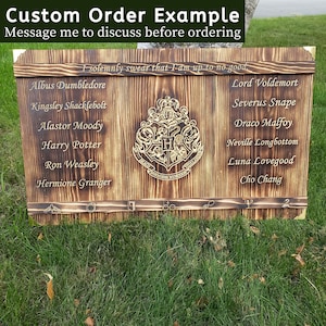 May include: A custom-made wooden sign with a dark, burnt finish. The sign features the Hogwarts crest and character names from the Harry Potter series, including Albus Dumbledore and Lord Voldemort. The text "Custom Order Example" is at the top.