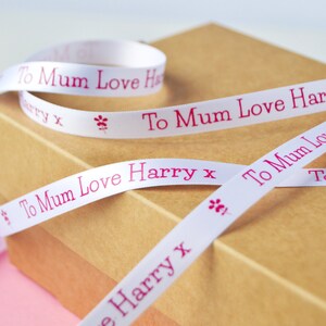 May include: White satin ribbon with pink lettering that reads "To Mum Love Harry x".