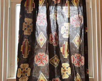 May include: A brown curtain with a geometric pattern in shades of red, gold, and white. The pattern features repeating diamond shapes and crosses.