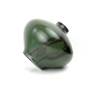 May include: A green ceramic vase with a rounded body and a narrow neck. The vase has a dark green glaze with black streaks and swirls.