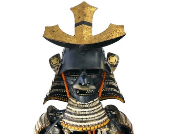May include: A black samurai helmet with gold accents and a red and orange face mask. The helmet is decorated with small, white beads and has a gold and black crest on top.