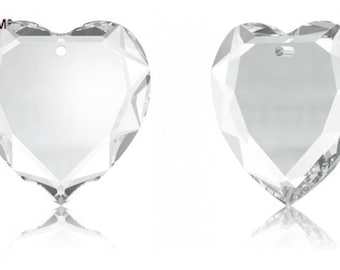 May include: A clear crystal heart-shaped pendant with a hole at the top for hanging. The pendant has a faceted design and is reflective.
