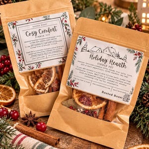 May include: Two brown paper pouches labelled Rooted Roost containing dried botanicals for simmer pots. The left pouch is labelled Cozy Comfort, and the right pouch is labelled Holiday Hearth, both featuring festive illustrations and instructions.