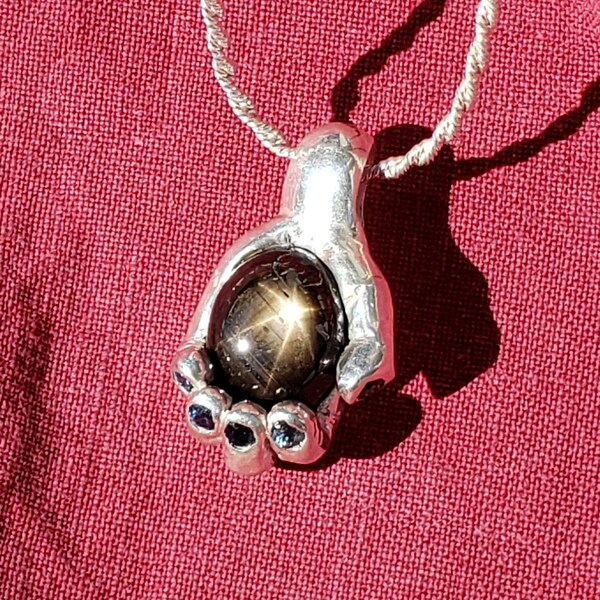 Handful of star, sapphire pendant