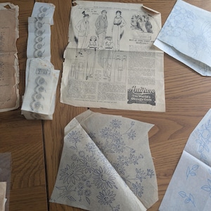 May include: A collection of vintage paper embroidery transfer patterns featuring floral designs and a printed advertisement page with illustrations of clothing and the text Antipon The World's Obesity Cure, alongside a strip labelled Briggs 3725.