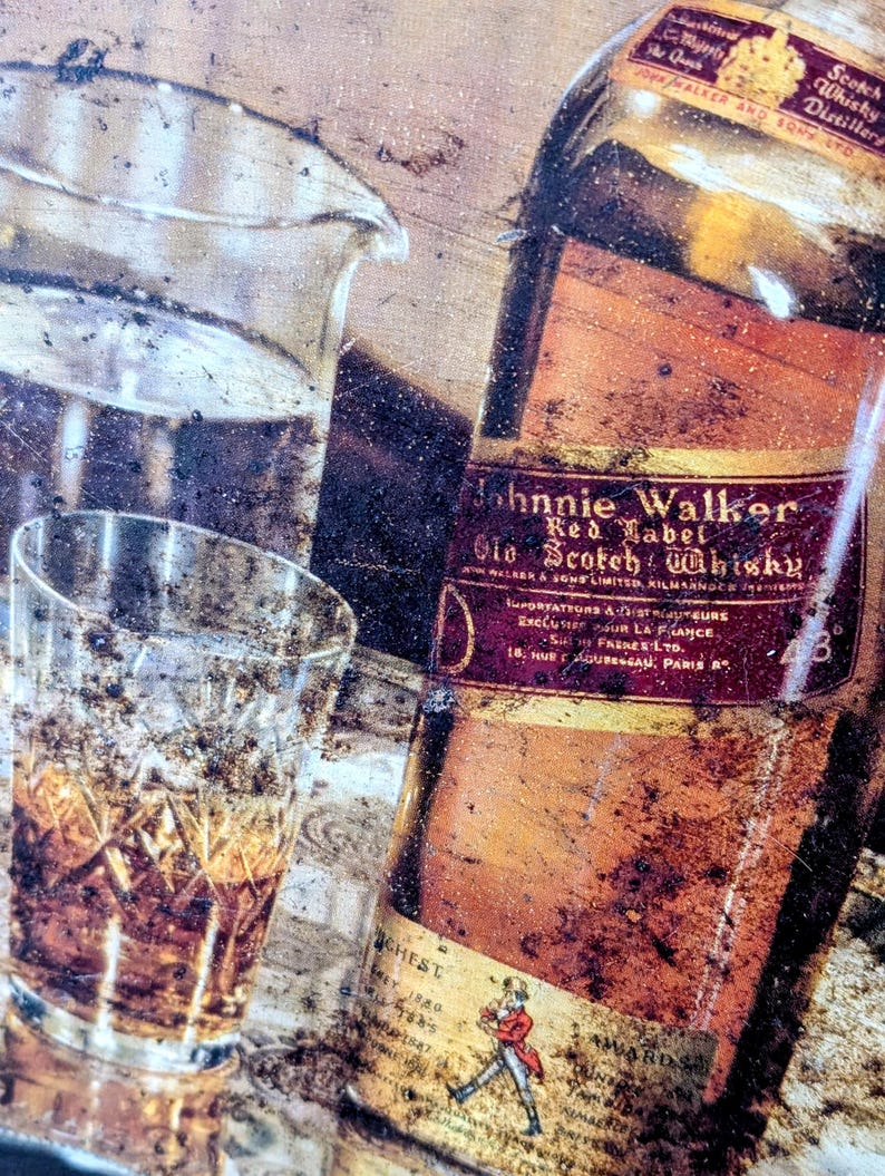 May include: An aged, vintage-style image featuring a bottle of Johnnie Walker Red Label Old Scotch Whisky, a glass of whisky, and a clear glass pitcher. The bottle has a red label with gold lettering. The image has a rustic, weathered appearance.