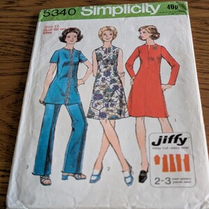 May include: A Simplicity 5340 sewing pattern envelope for size 14, bust 92 cm. The cover features illustrations of three outfits: a blue tunic and trousers set, a sleeveless floral dress, and a long-sleeved red dress, with the text Jiffy easy cut easy sew.