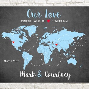 May include: A chalkboard with a blue world map showing a route between two red hearts. The text reads "Our Love Crossed 6,711 MI 10,800 KM May 1, 2017 Mark & Courtney".